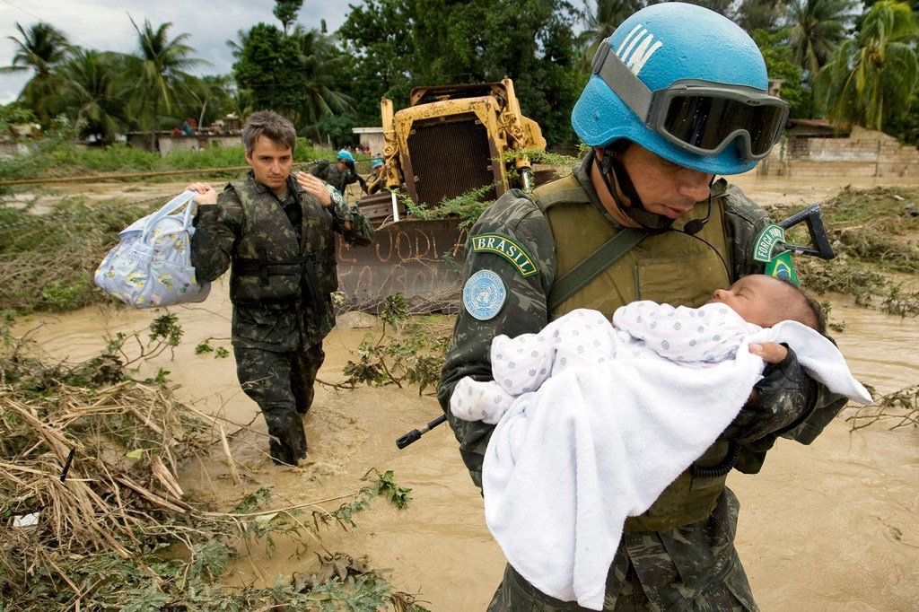 A UN peacekeeper rescues a child after parts of the capital of Haiti, Port-au-Prince were flooded during a tropical storm in 2007.